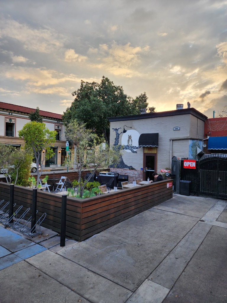 The Night Owl Patio and Owl Mural at Dusk